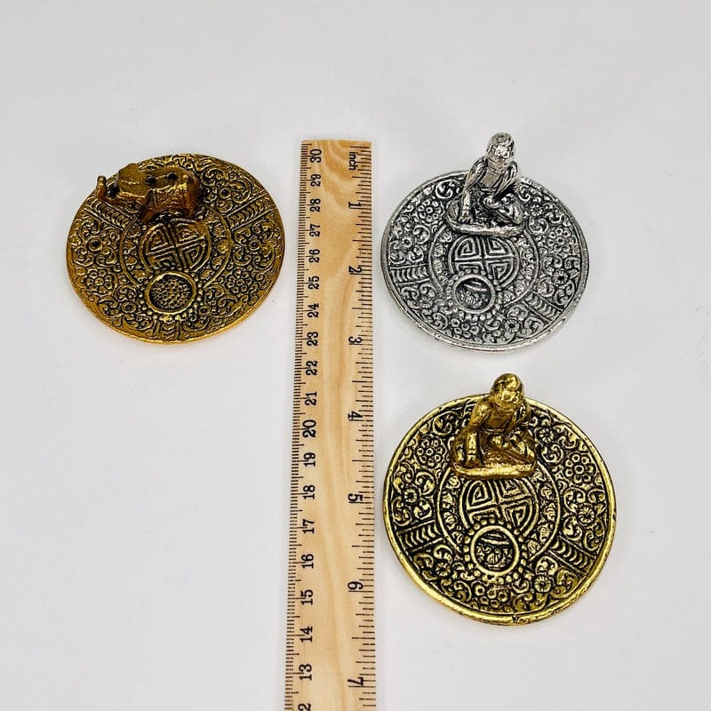 incense burners next to a ruler for size reference 