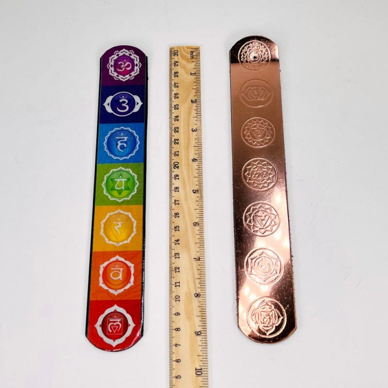 incense sticks next to a ruler for size reference 