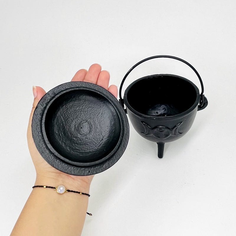 caldron lid in hand for size reference 