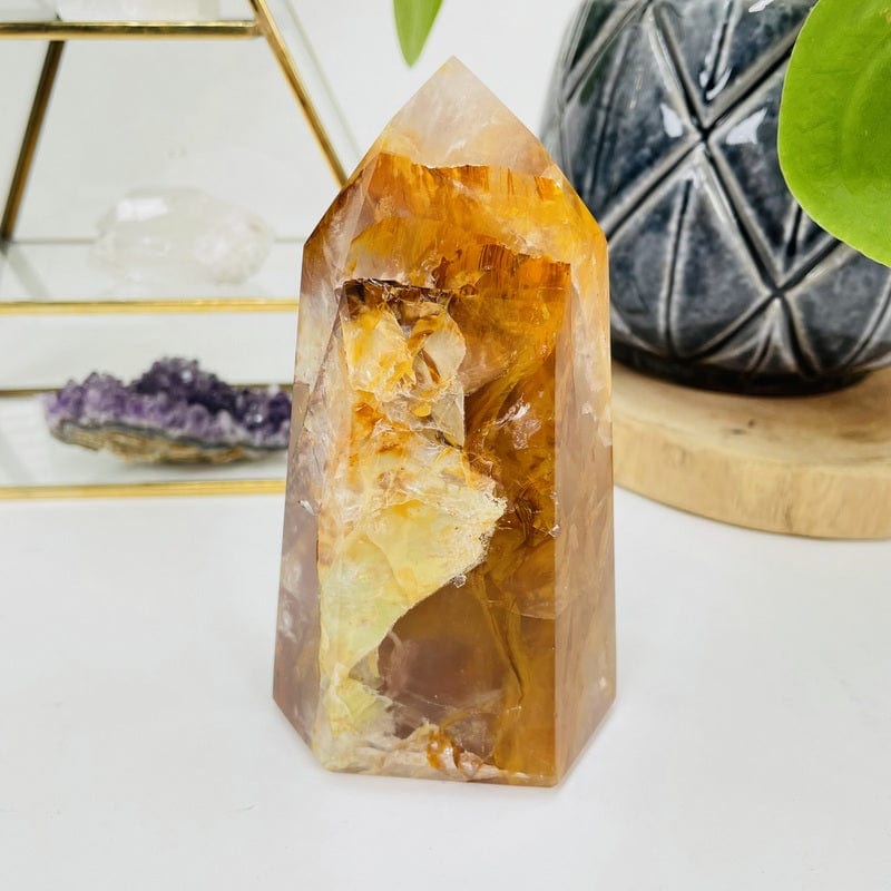 golden healer polished point displayed as home decor