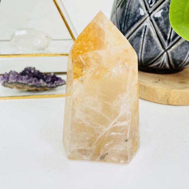 golden healer polished point displayed as home decor 