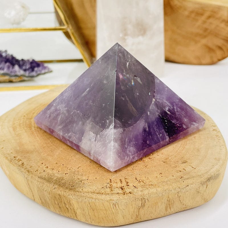 close up of an amethyst pyramid set as home decor 