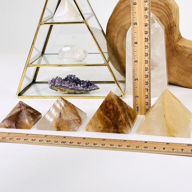 pyramids next to a ruler for size reference 