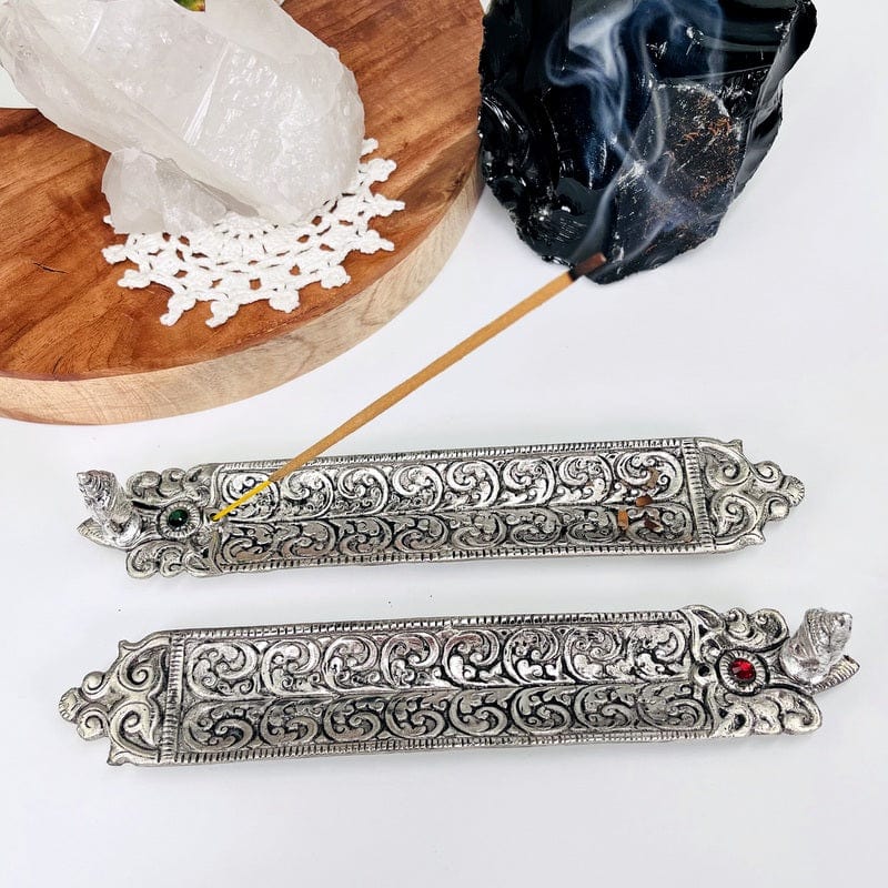 incense stick burners with color accent and buddha head displayed as home decor 