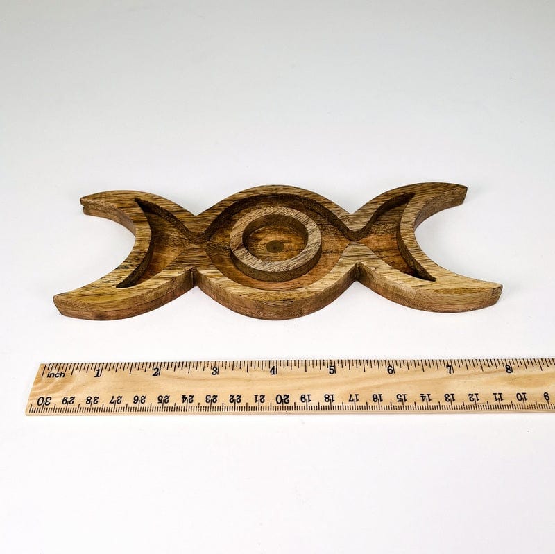 sphere holder next to a ruler for size reference 