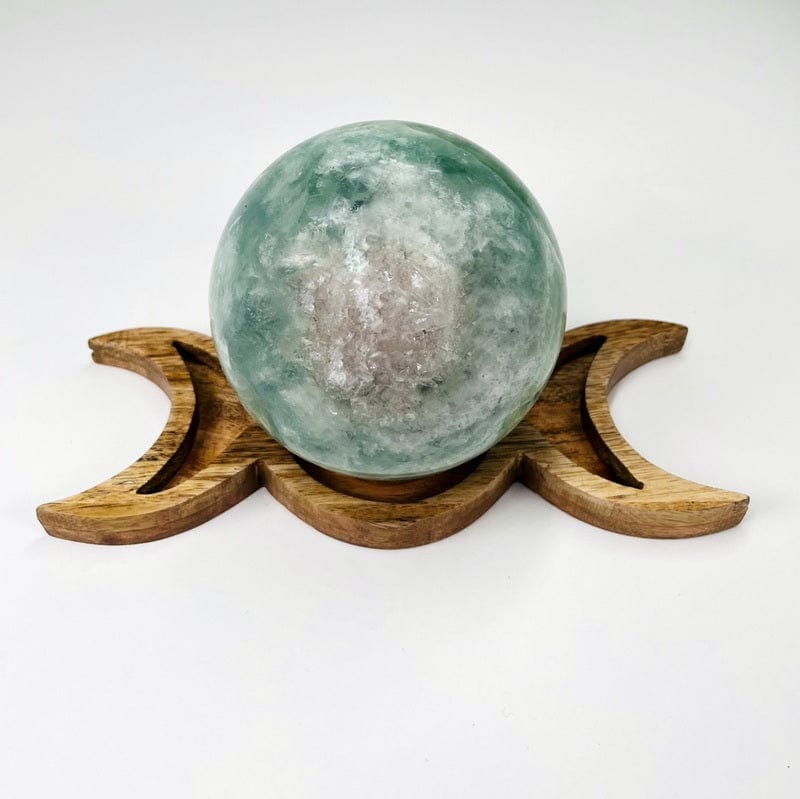 close up of a moon phases sphere holder with display sphere 