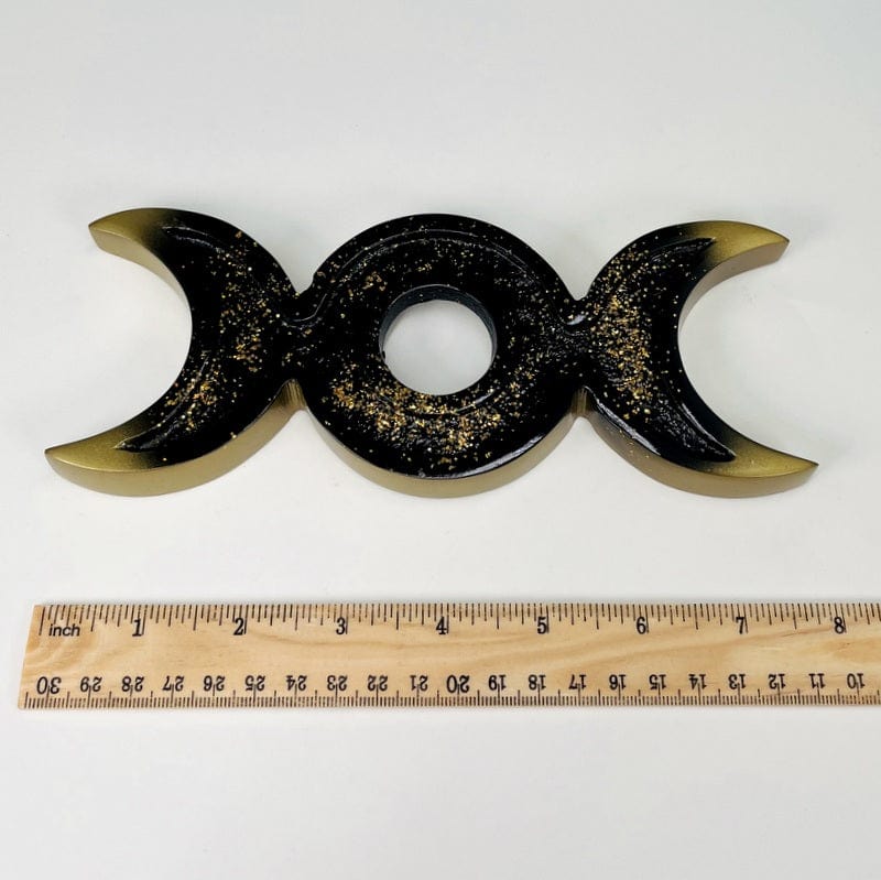 sphere holder next to a ruler for size reference 