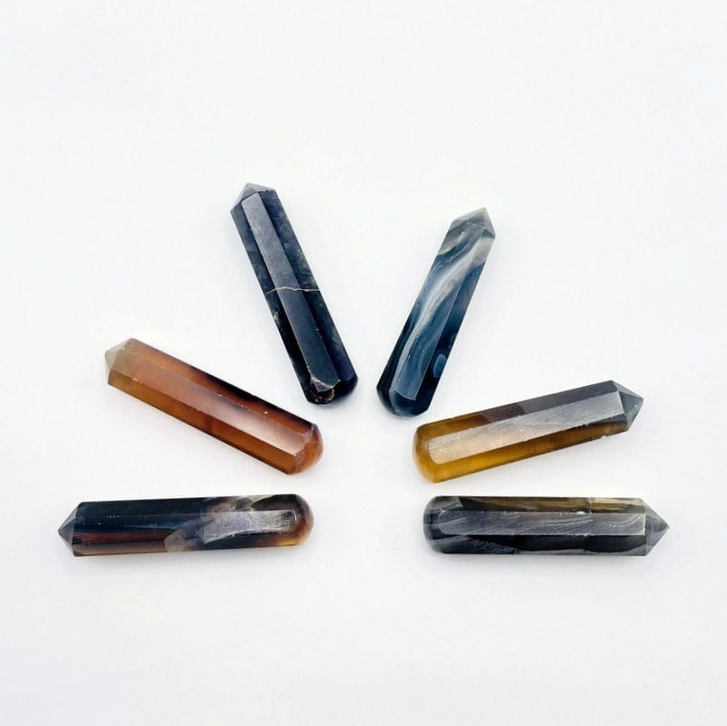 Yellow and green Fluorite massage wands on a  table