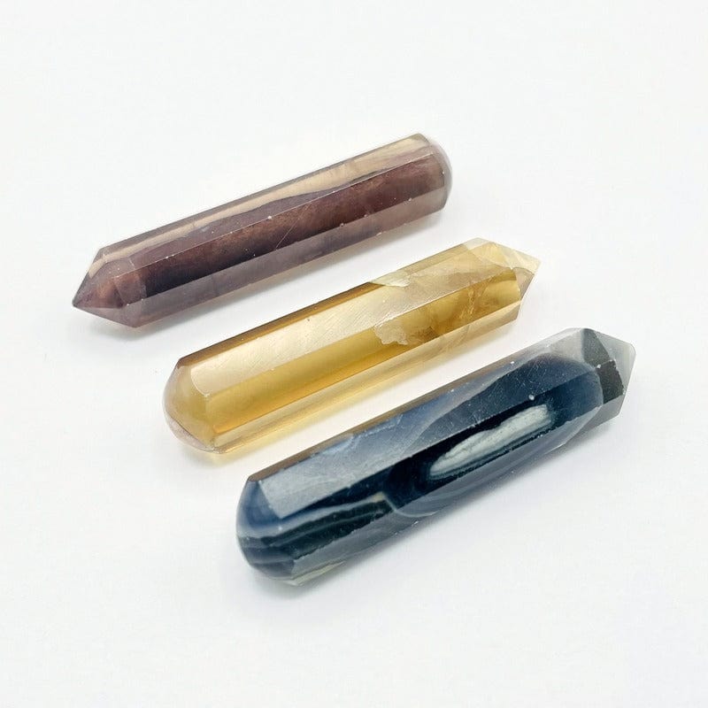 side shot of yellow and green Fluorite massage wands  - 3 on a table