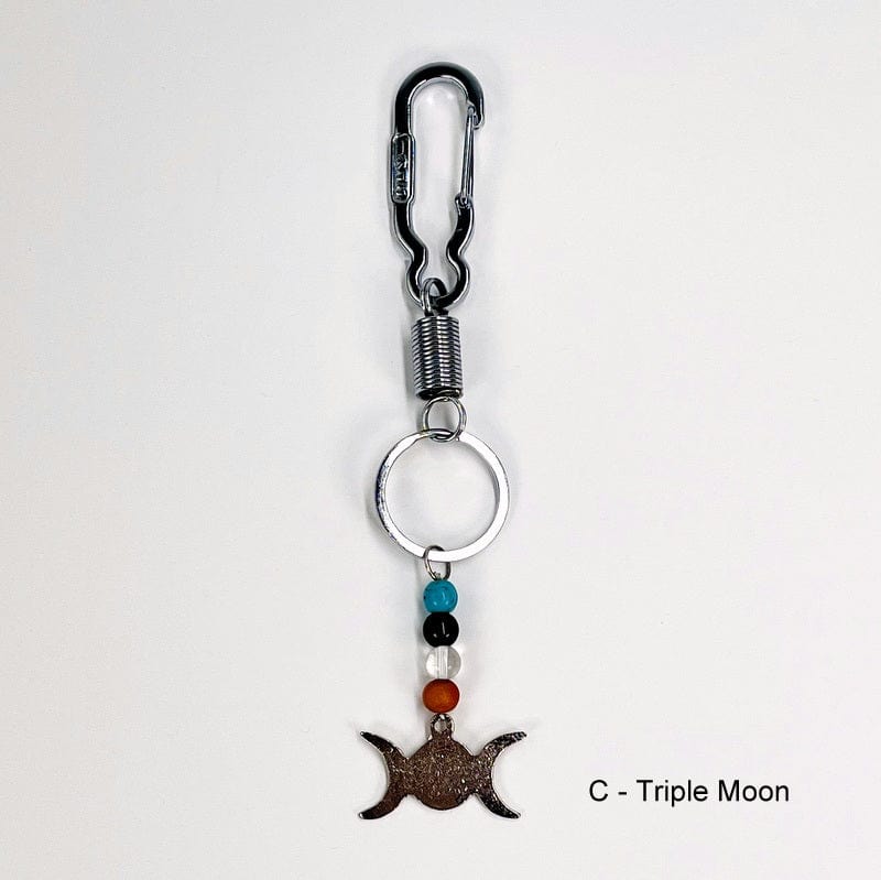 keychain with a triple moon charm decorated with a blue howlite, obsidian, crystal quartz and wooden bead