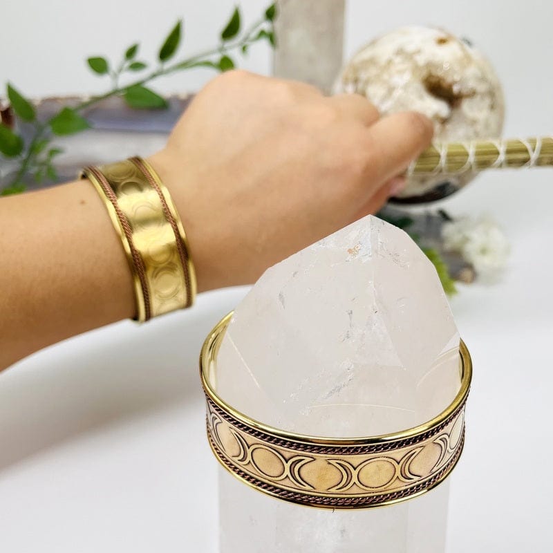 brass cuff bracelet on wrist to show the thickness 