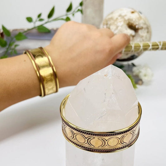 brass cuff bracelet on wrist to show the thickness 
