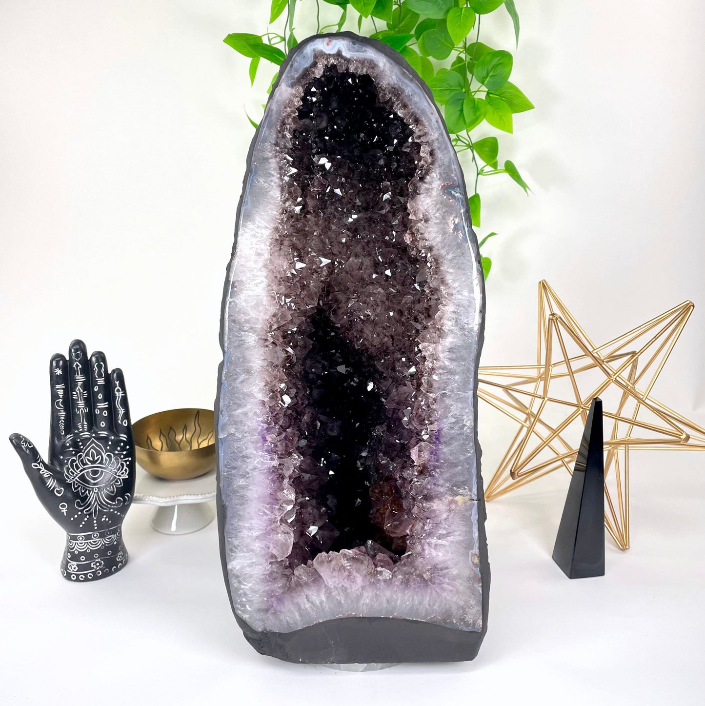 front of amethyst cave geode on display in front of backdrop