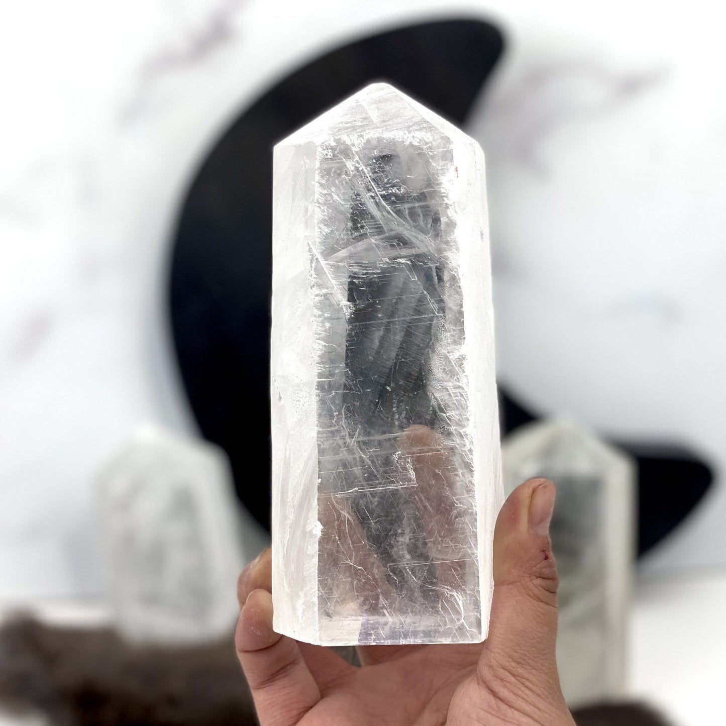 Polished Selenite Semi-Polished Point in a hand for size reference