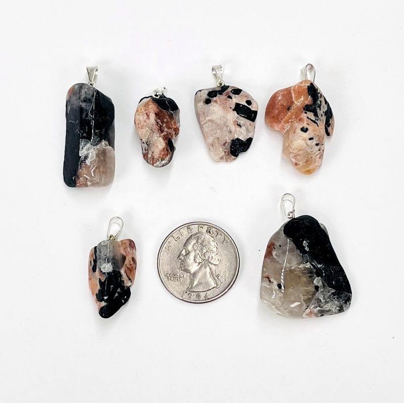 pendants next to a quarter for size reference 
