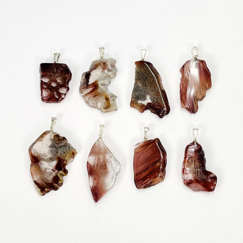 multiple pendants displayed next to each other to show the differences in the colors and sizes 