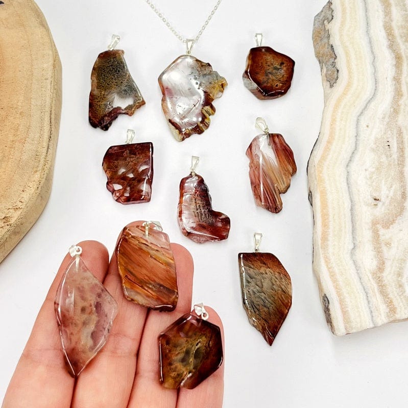 amphibole slice pendants in hand for size reference 