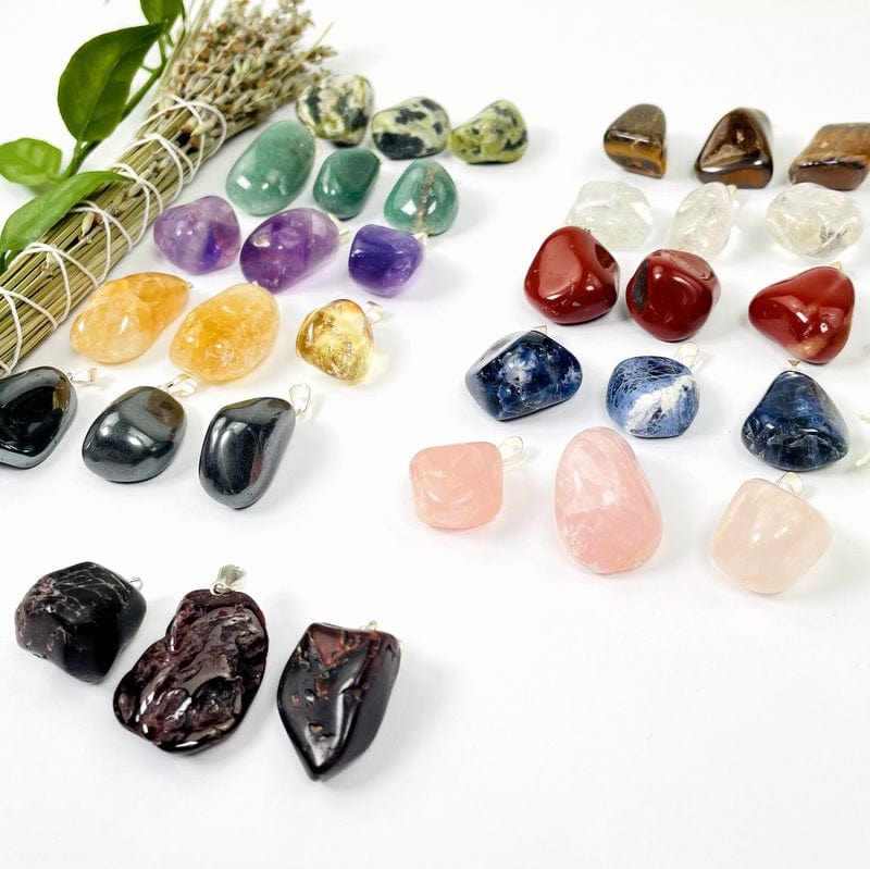 side shot of tumbled stone pendants with silver bails
