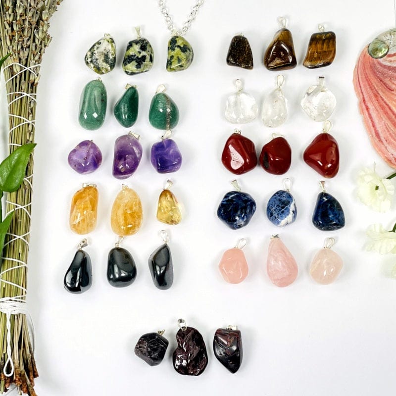 tumbled stone pendants with silver bails on white background 