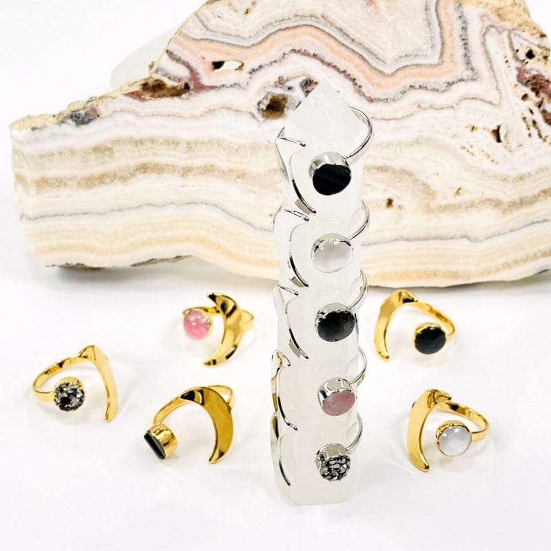 close up of silver and gold moon rings with gemstone accent