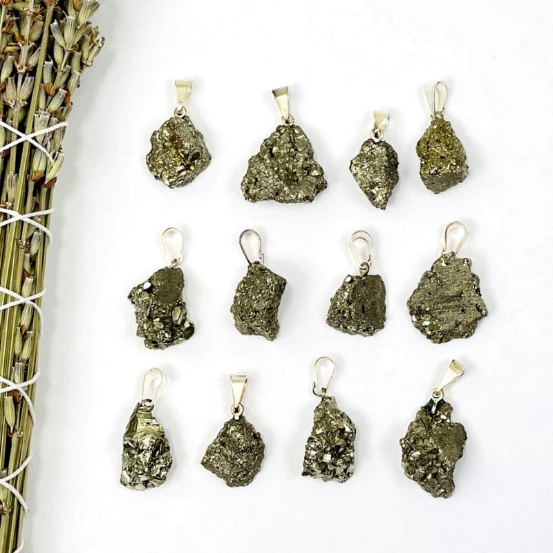 pyrite pendant with silver bail on white background 