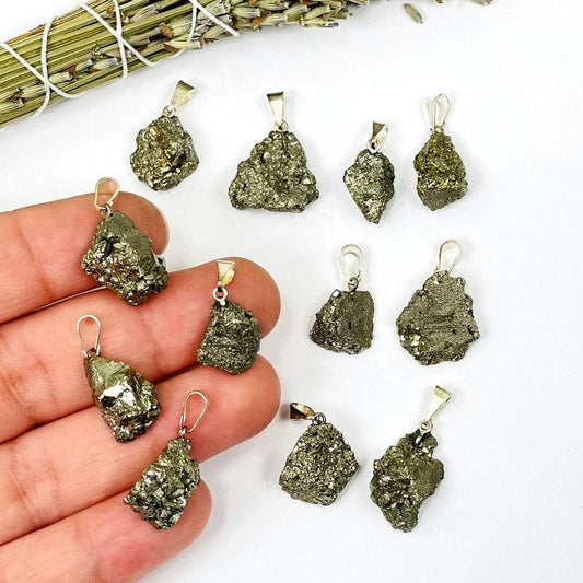 pyrite pendant with silver bail in hand for size reference 