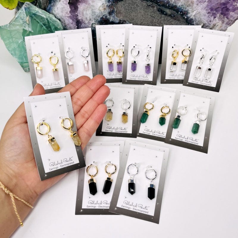 polished point earrings in hand for size reference 