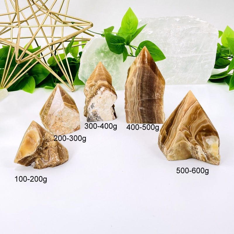 high grade aragonite semi polished points next to weight in grams 