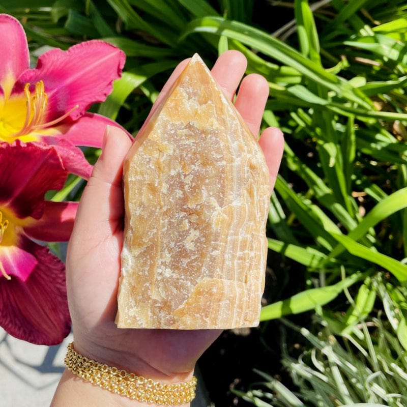 high grade aragonite semi polished point in hand  