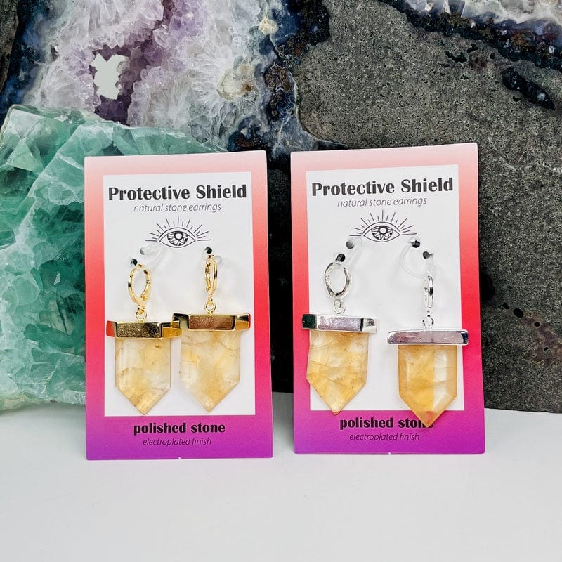 close up of the protective shield earrings in citrine (heat treated) electroplated in gold or silver