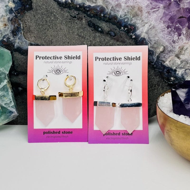 close up of the protective shield earrings in rose quartz electroplated in gold or silver