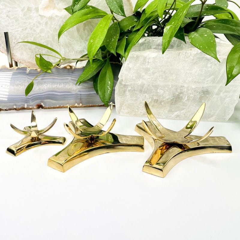 All three sizes of gold tone sphere holders in the lowered position on a white background.