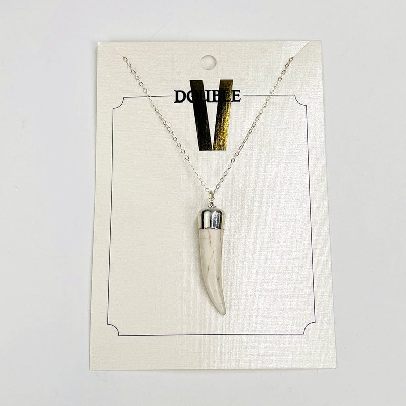close up of the details on the white howlite horn pendant. comes with a silver cap and bail on a silver chain 