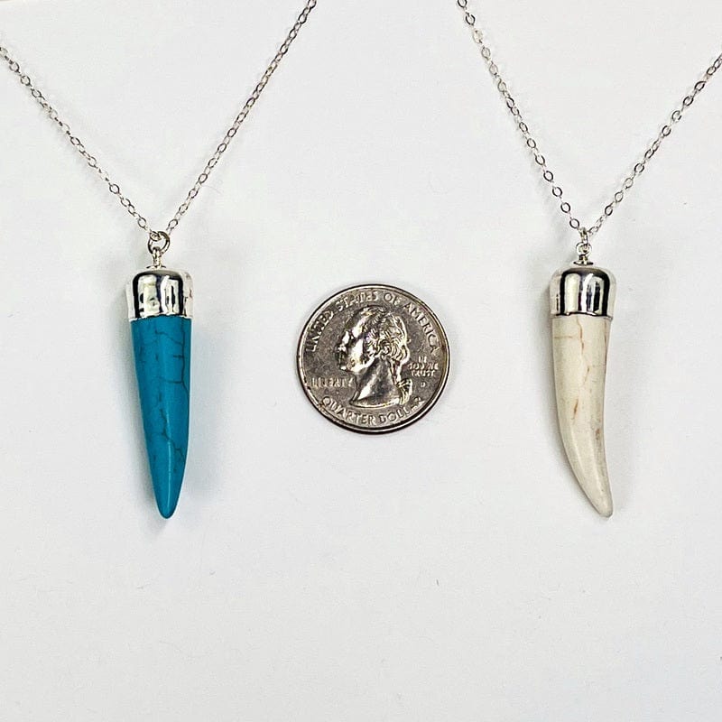 pendants next to a quarter for size reference 