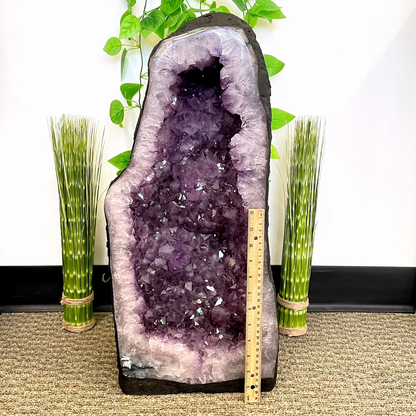 front of amethyst cave geode with vertical ruler for height reference