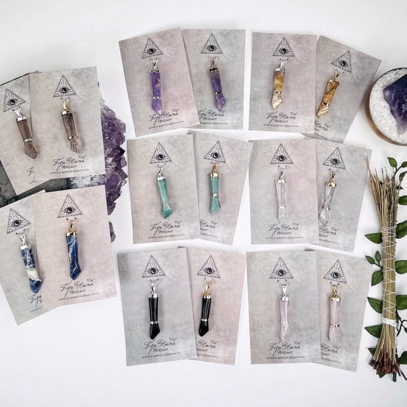 all the pendants available in silver or gold displayed to show the differences in the crystal stones 