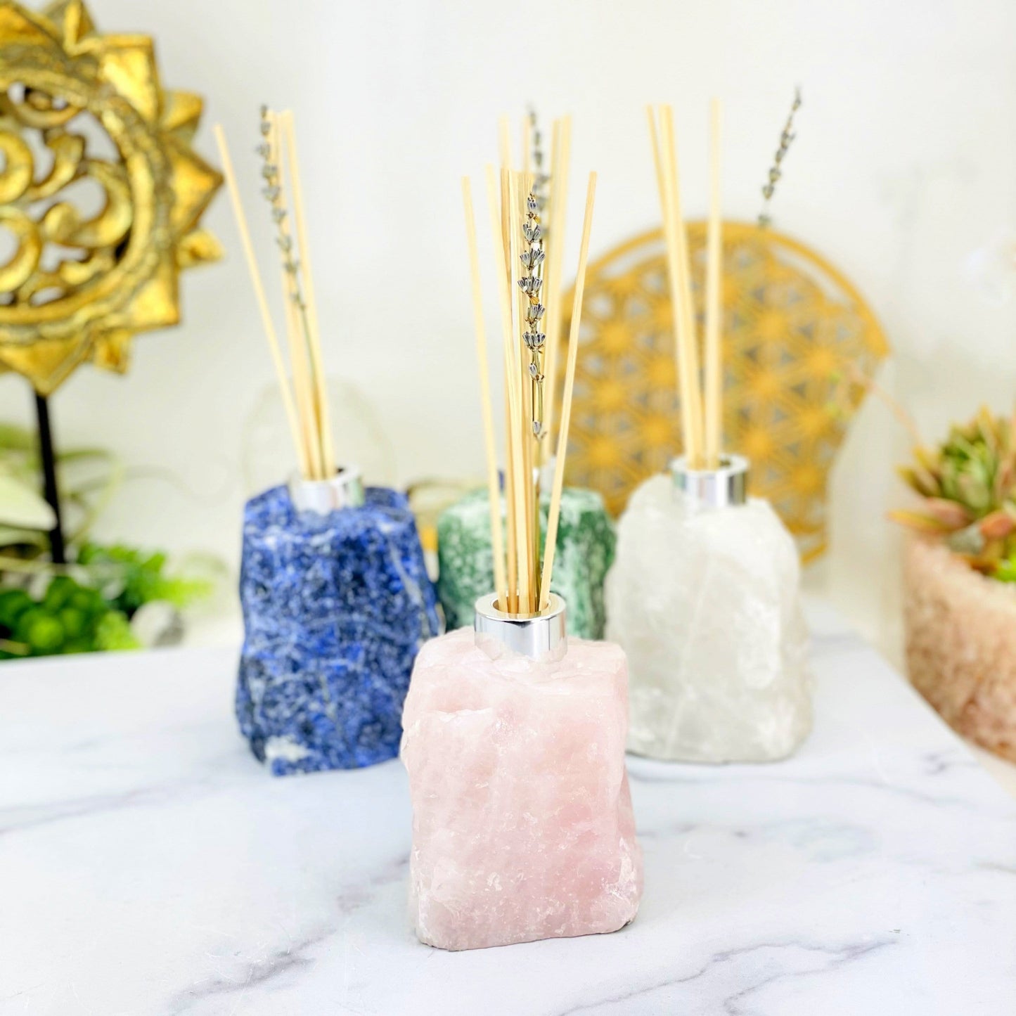 1 Rough Stone Diffuser Bottle up close while 3 others are blurred in the background with decorations