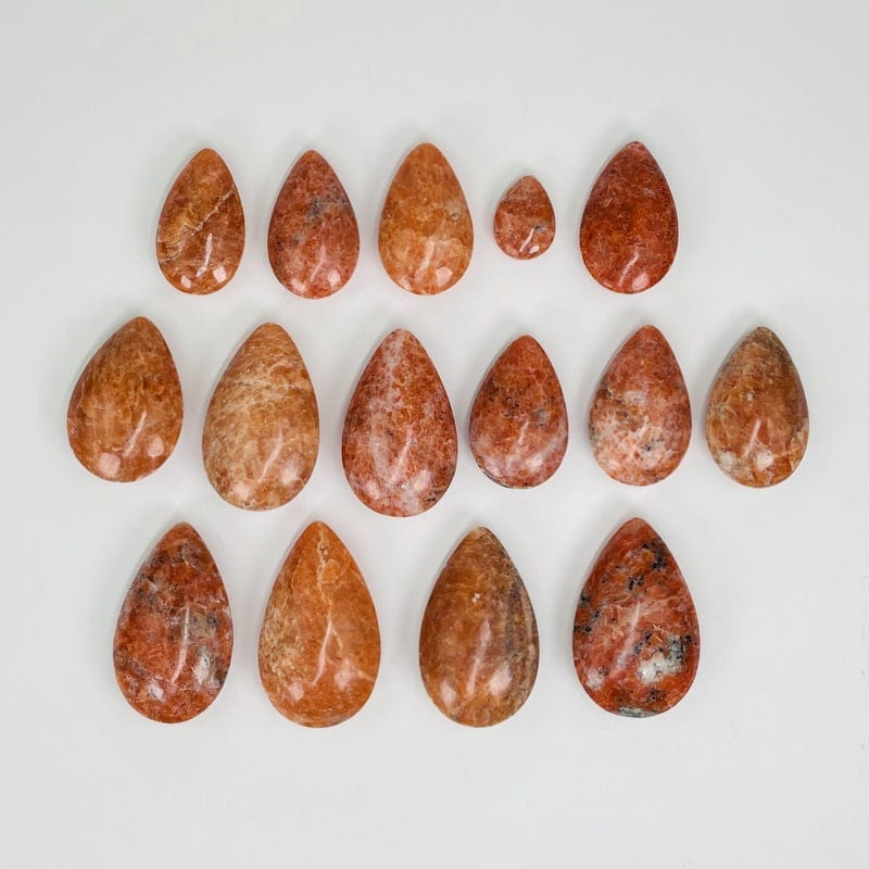 multiple orchid drops displayed to show the differences in the color shades and sizes 