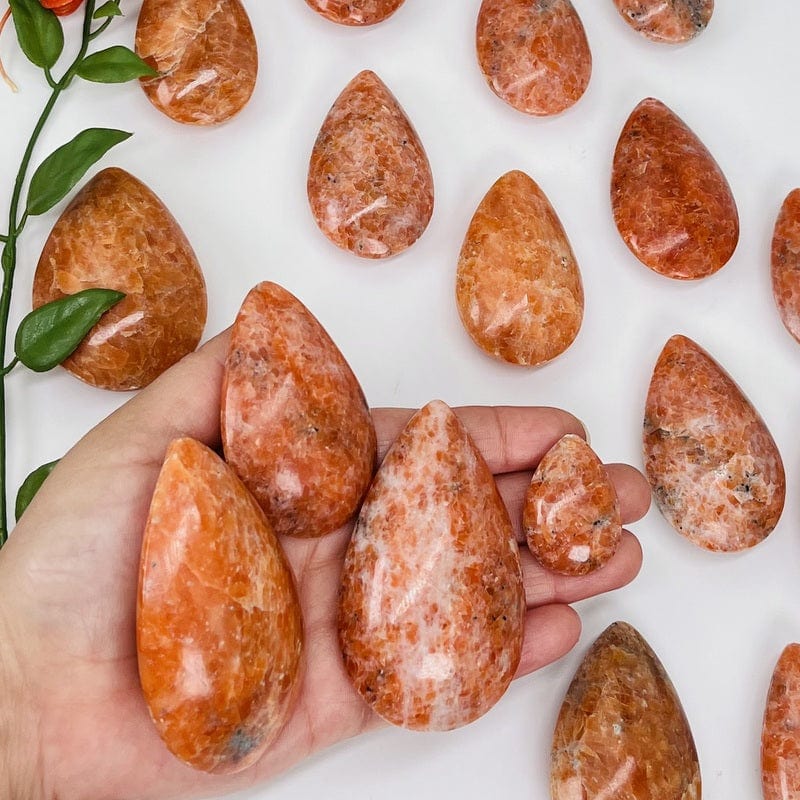 orchid calcite drops in hand for size reference 
