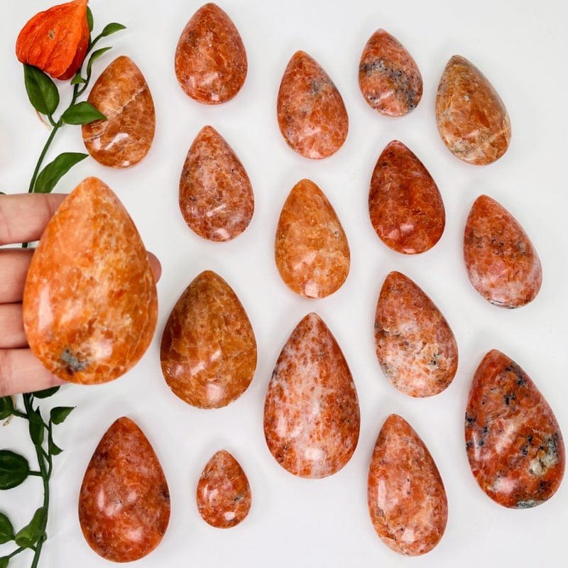 orchid calcite drop shape in hand for size reference 