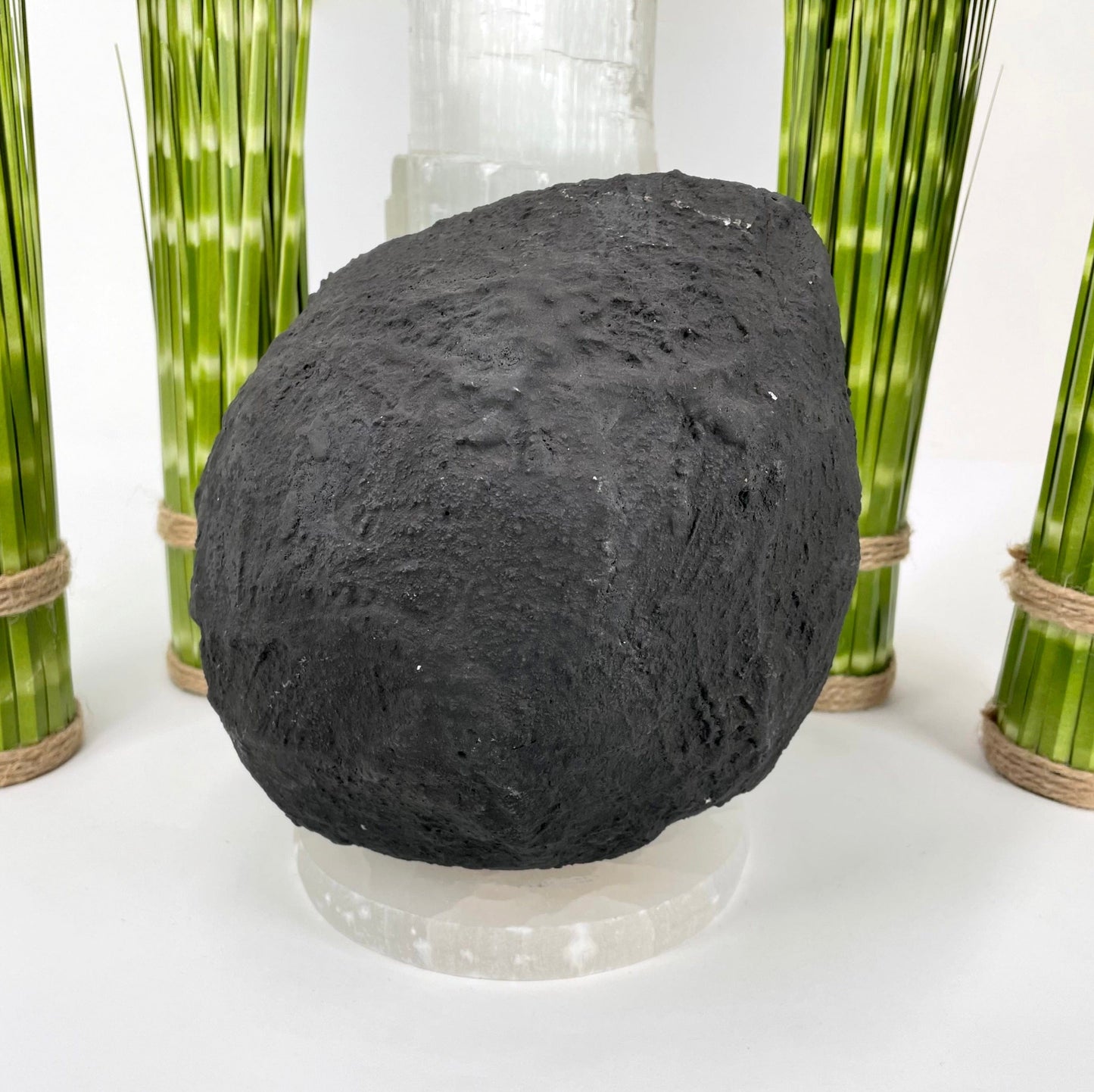 back of amethyst round cave geode on display in front of backdrop