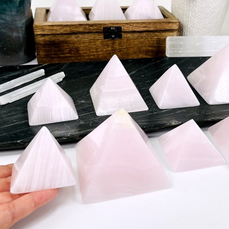 small pink calcite in hand showing the size difference 