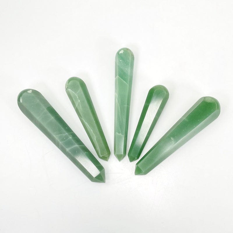 green quartz polished massage points on white background