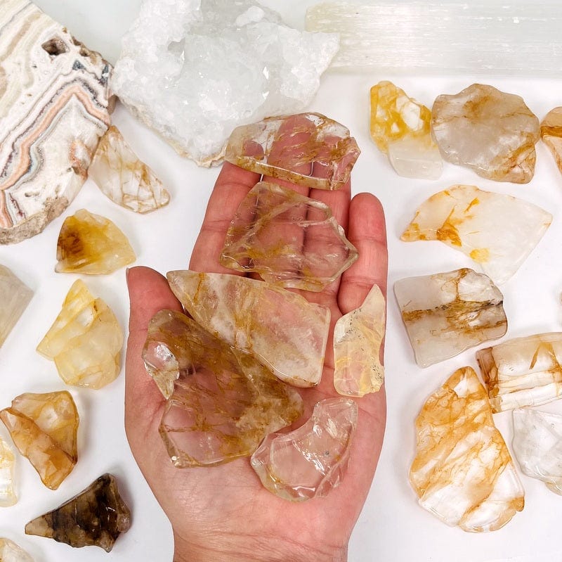 golden healer stone semi polished slabs in hand for size reference 