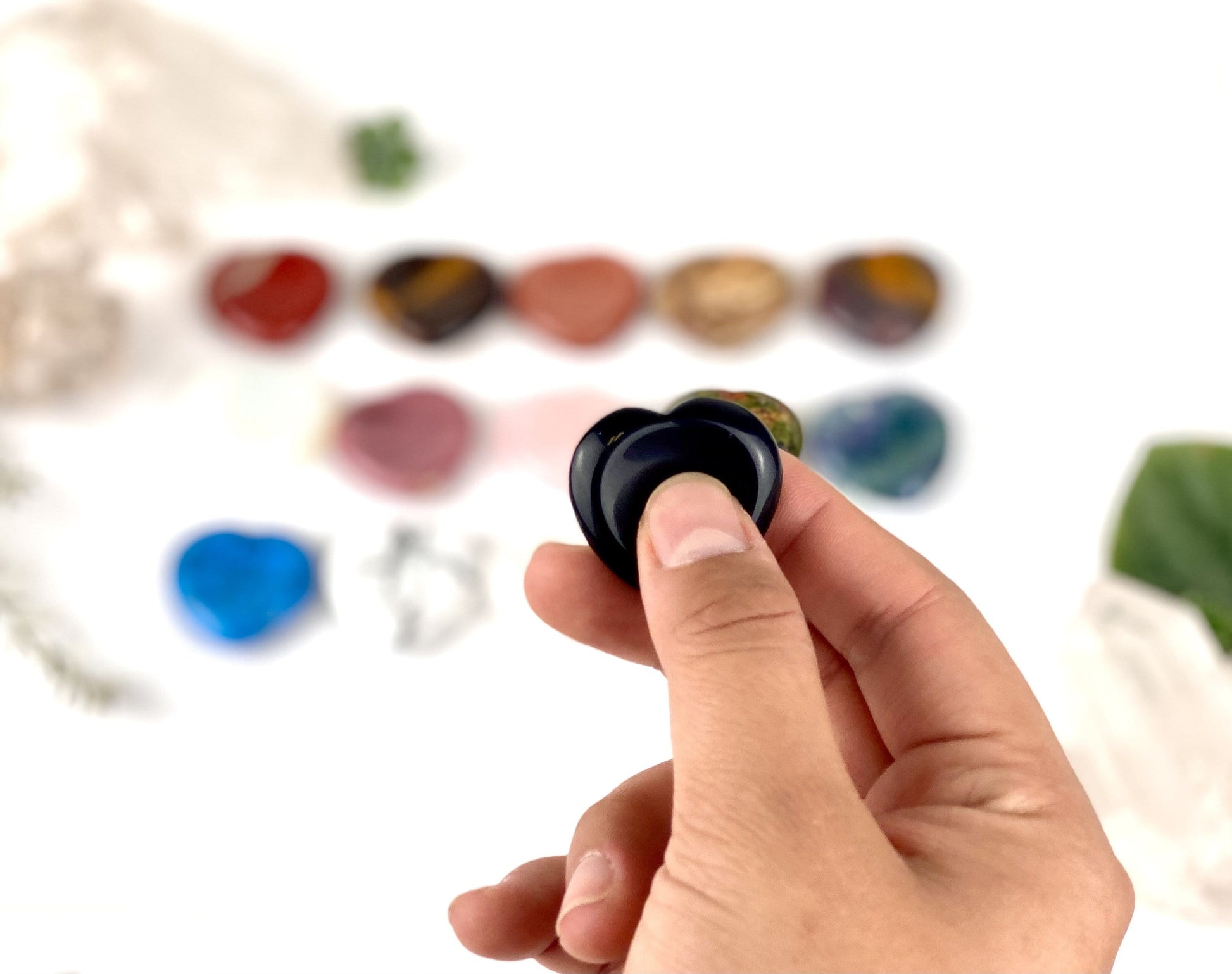 Gemstone Heart Worry Stone displayed with thumb in the indentation