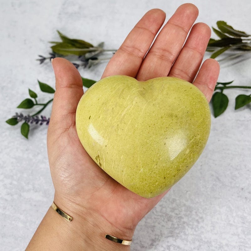 green/pistachio opal polished heart in hand for size reference 