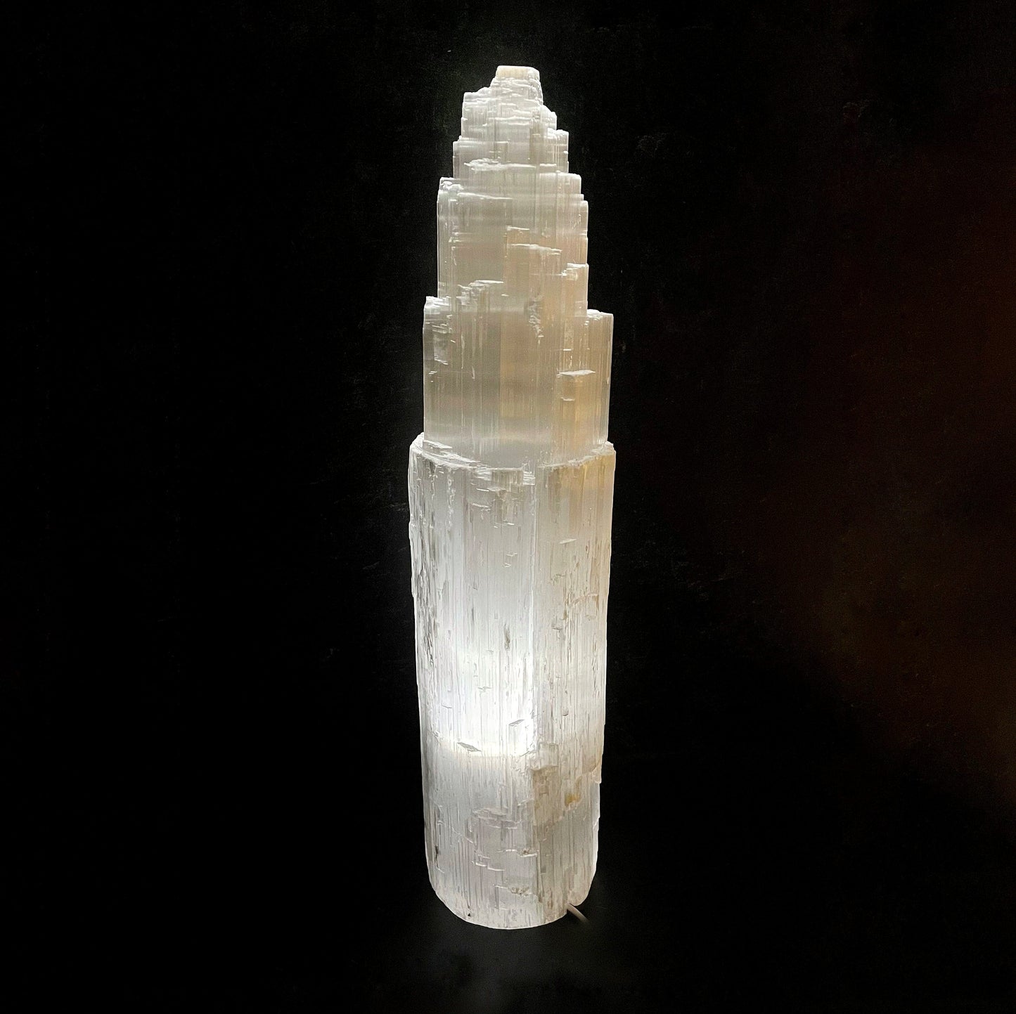 selenite xxl lamp lite up on black background