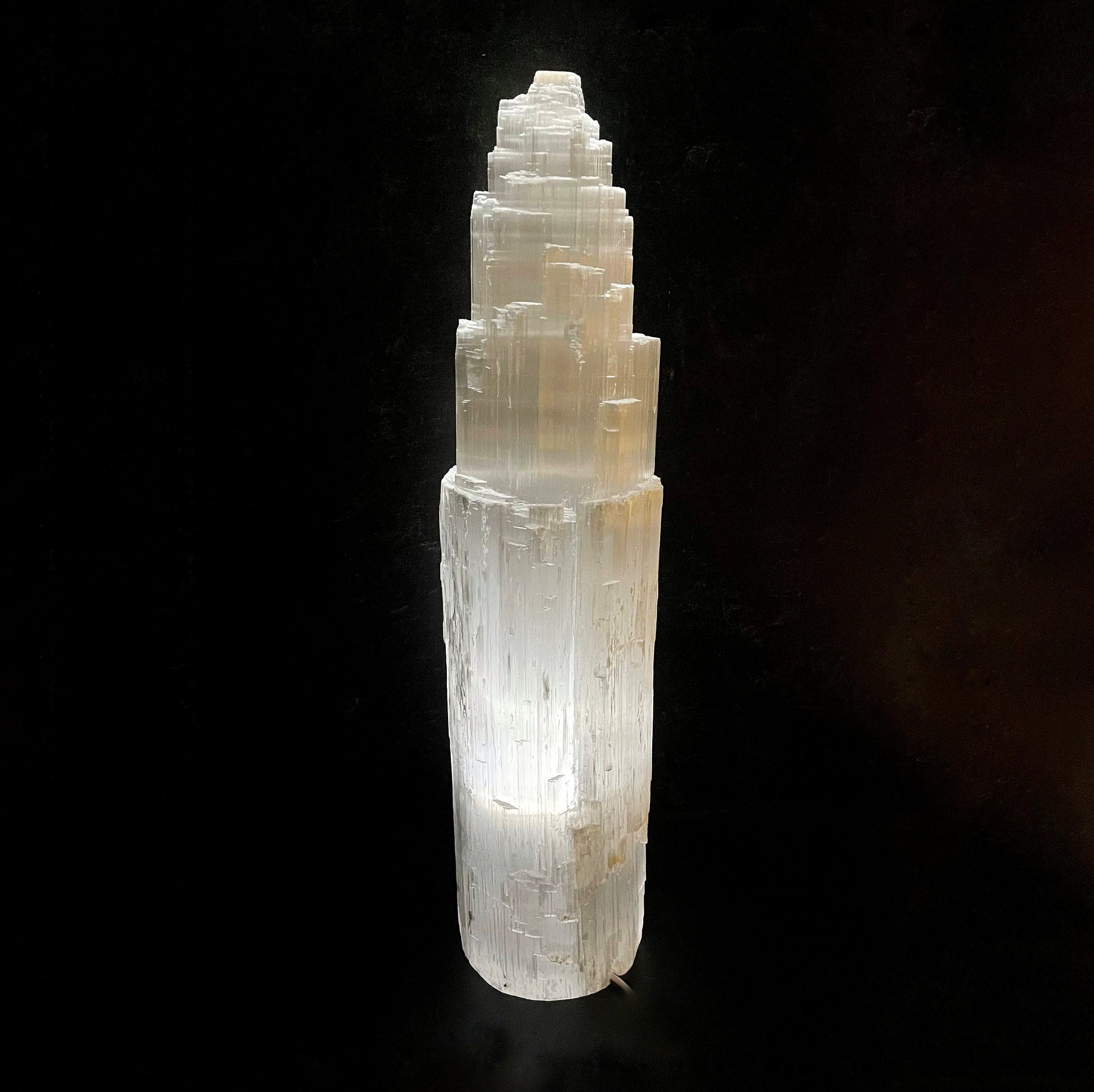 selenite xxl lamp lite up on black background