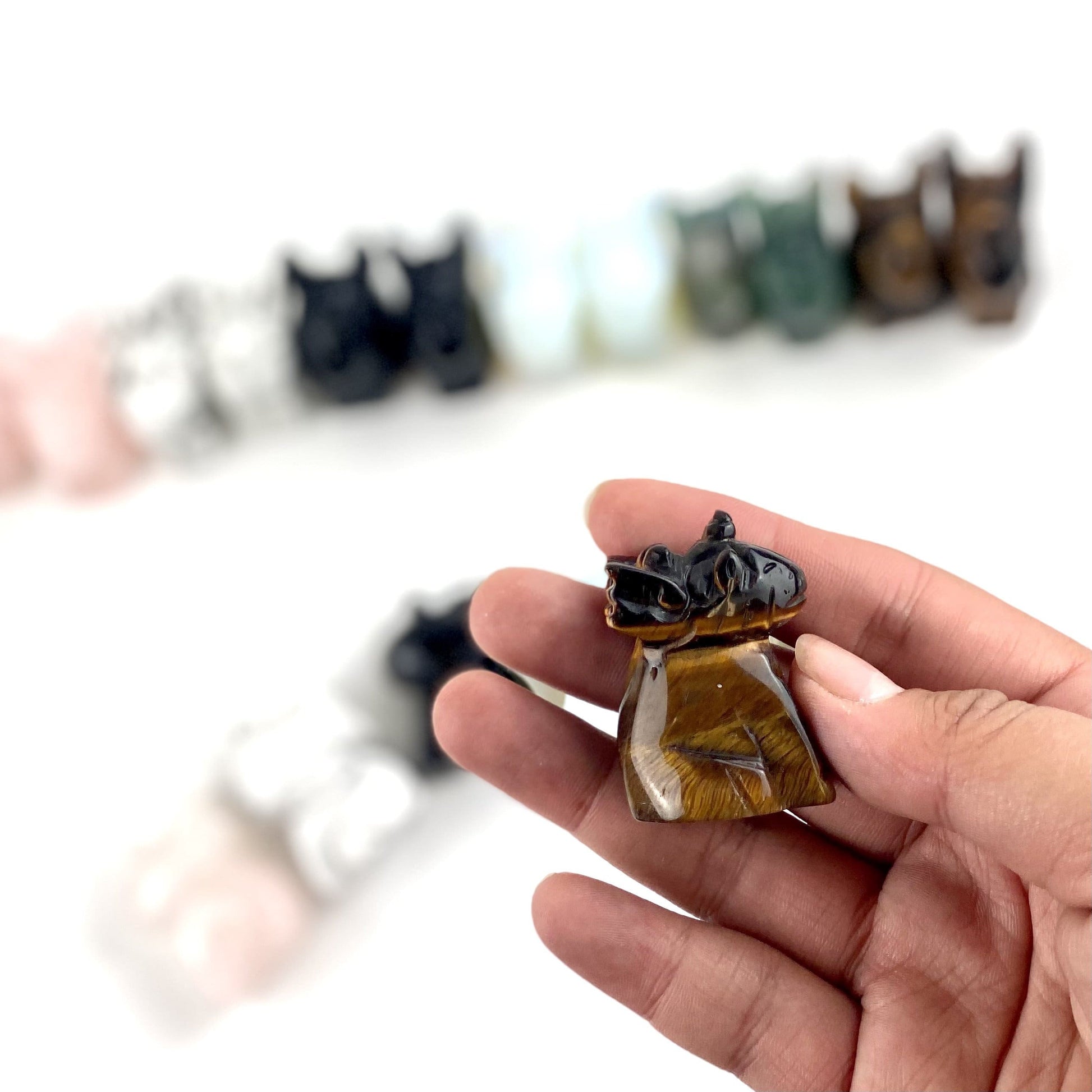 Tigers eye Gemstone Unicorn Dragon on hand for size comparison