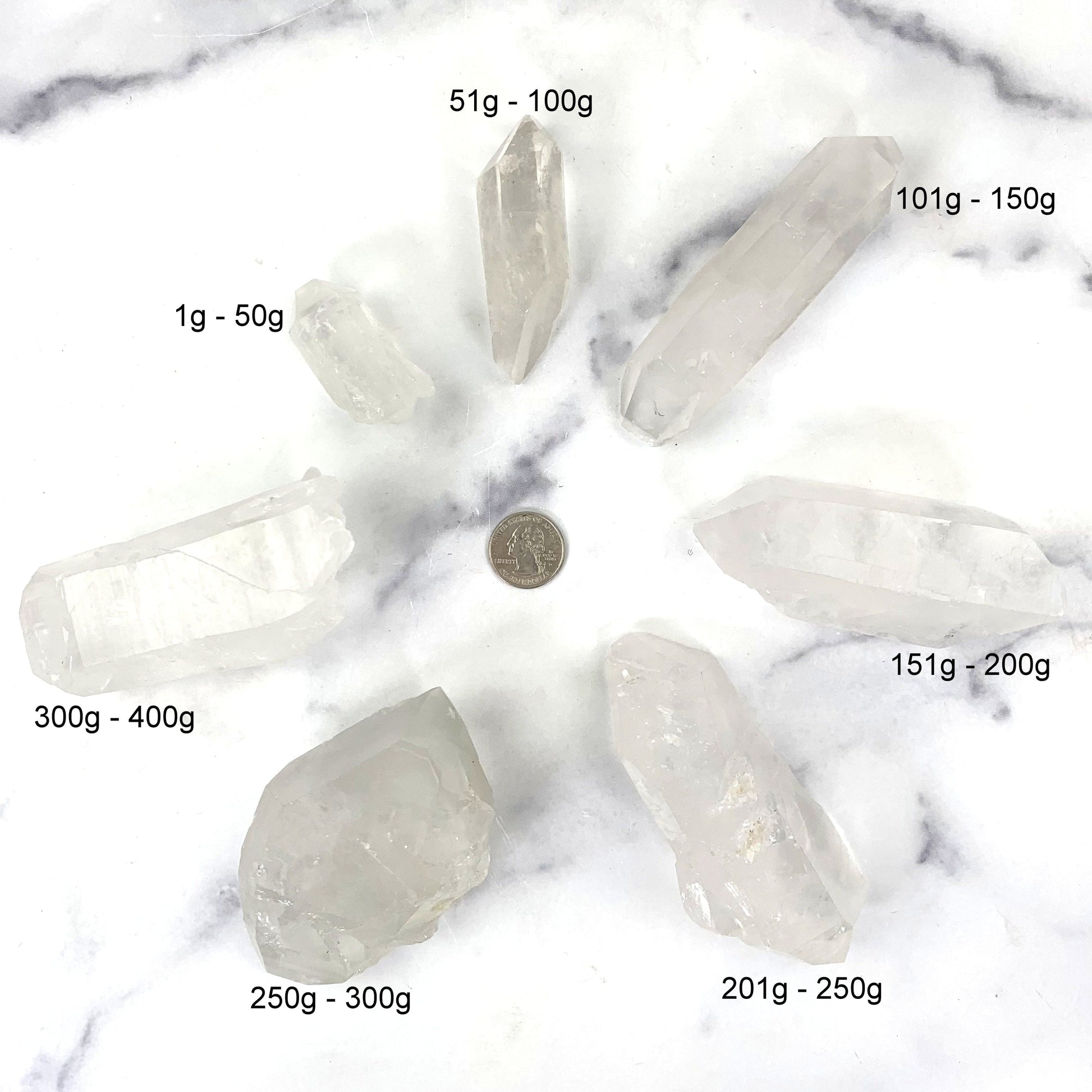 all7 variations surrounded by a quarter on marble background